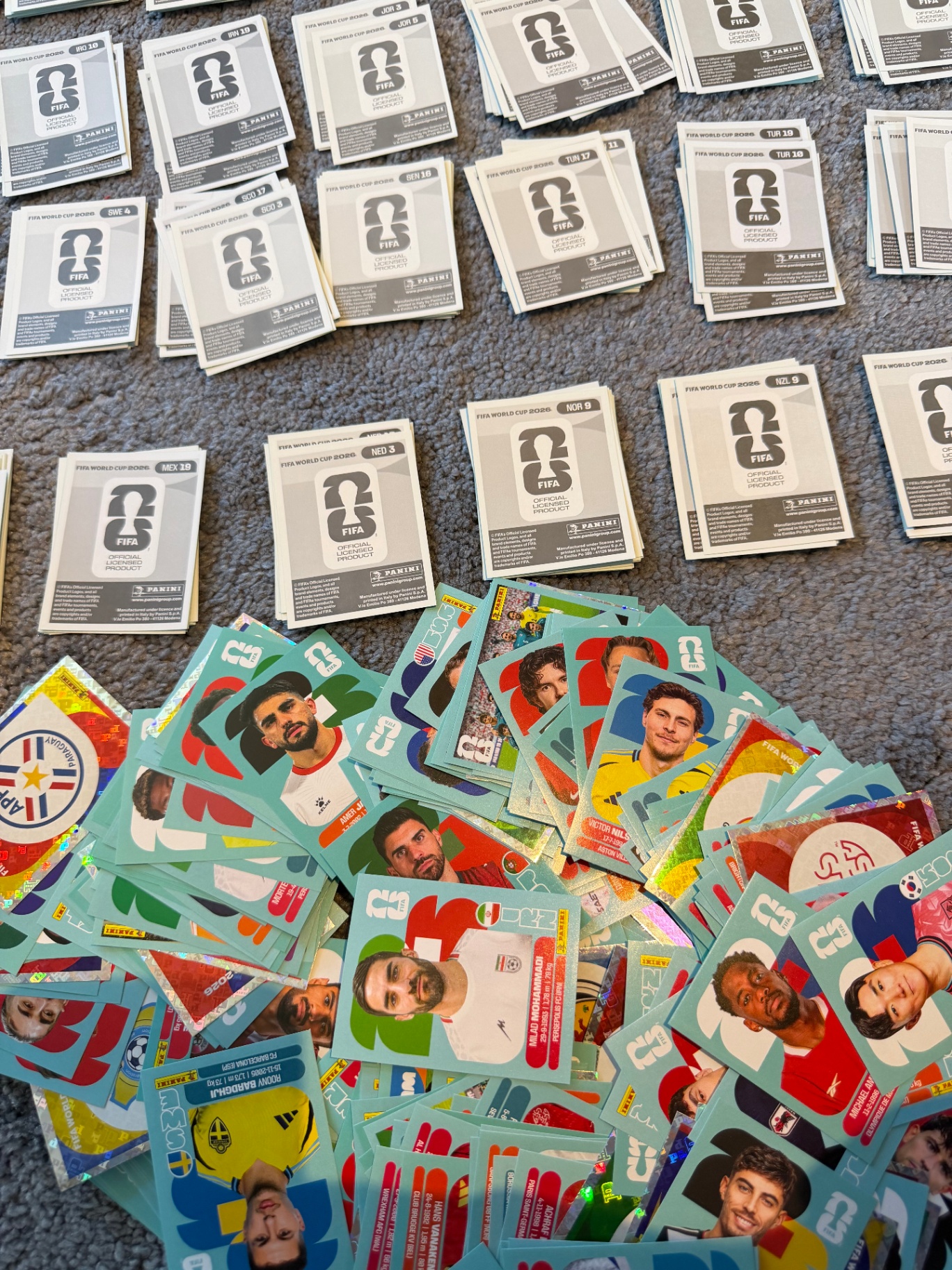 Open sticker album with packs